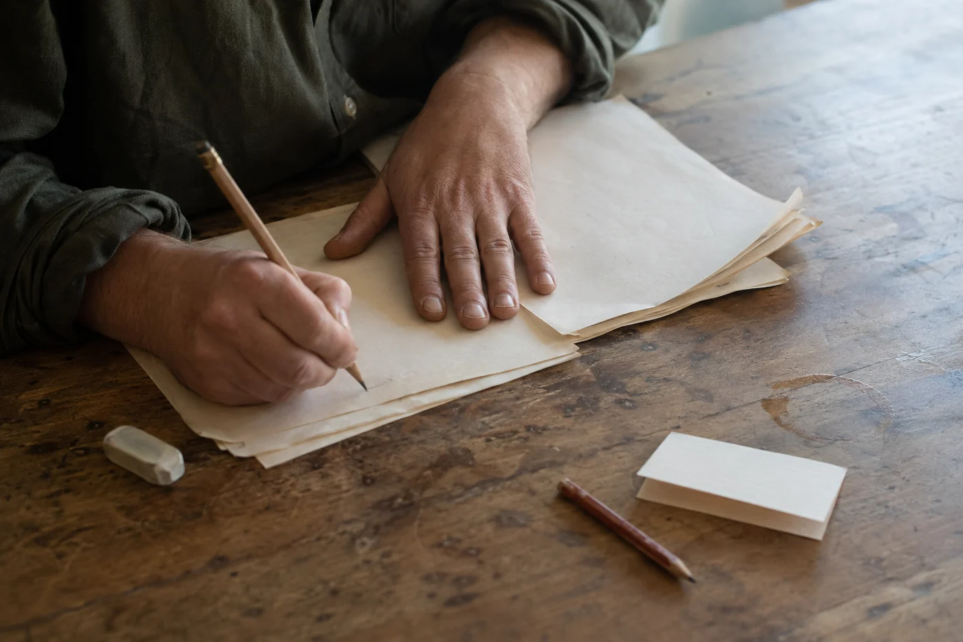 A writer revising a manuscript by hand