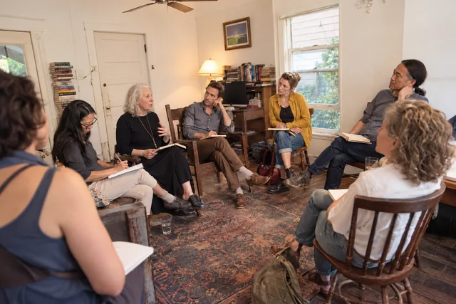 Writers sit in a circle and listen during an intimate workshop