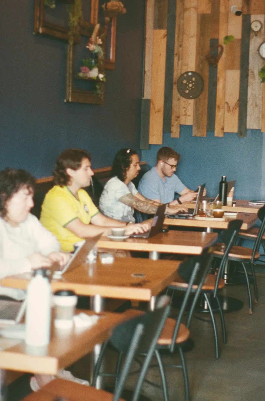 Writers working along a row of tables during an ATX Writing Club course session