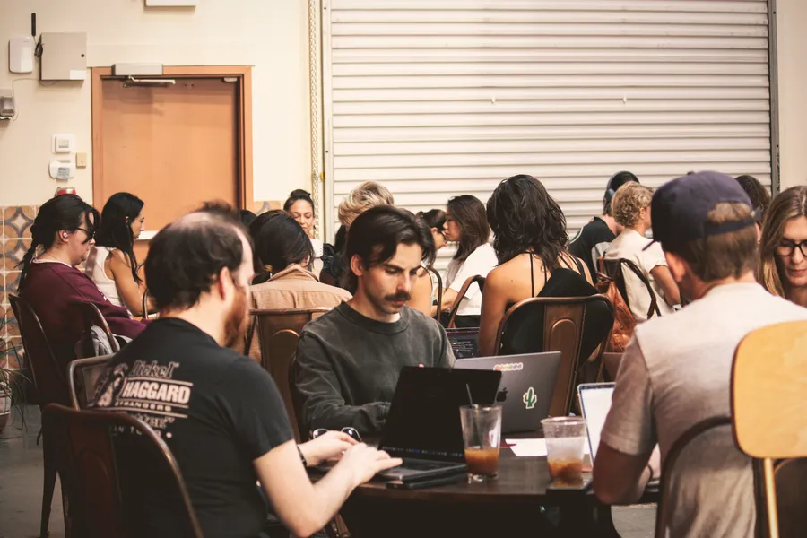 A room full of ATX Writing Club members writing together