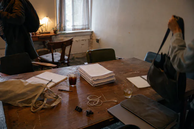 A manuscript and empty chairs at the end of a writing session